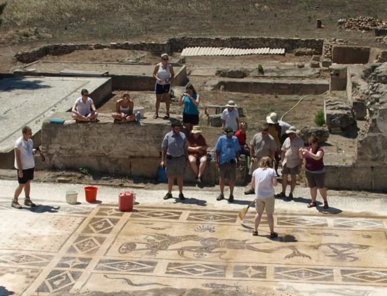 A group of people standing by an excavation site.