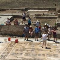 A group of people standing by an excavation site.